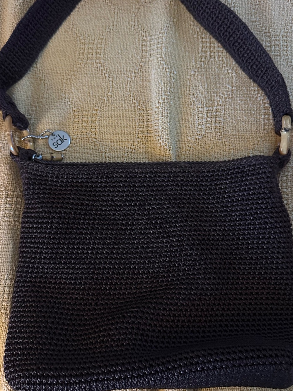 The Sak Bronw Crochet Shoulder Bag with Signature Charm